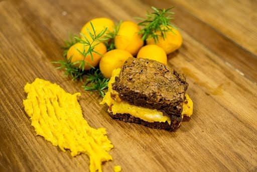 um brownie recheado com brigadeiro de pequi